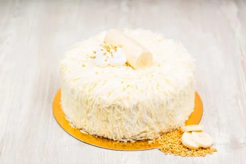 The cake and slices of banana on the table Stock Photos