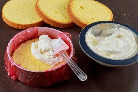 Cake assembly. layer cake with icing. Stock Photos