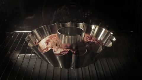 Cake in a baking dish. Accelerated filming. Raising the test for the eyes. Stock Footage 76502595