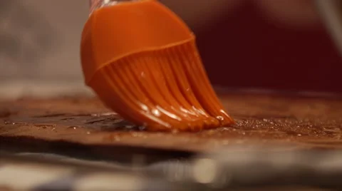 Cake base spreading with silicon brush close-up in slow motion Stock Footage 49075944