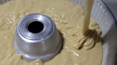The cake batter falls into the pan in slow motion. Video stock 243021554
