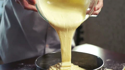 Cake batter pouring into baking dish. Home baking. Baking cake Stock Footage 62414078