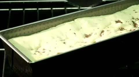A cake being baked in a loaf tin in the oven (time lapse) Stock Footage 24673279