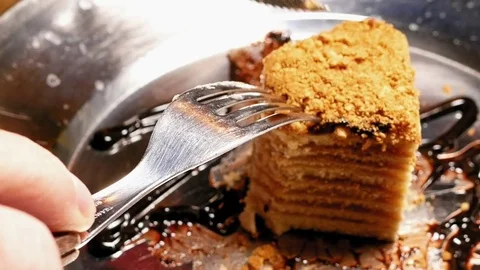 Cake being cut with fork and knife. Close up shot. Stock Footage 69963954