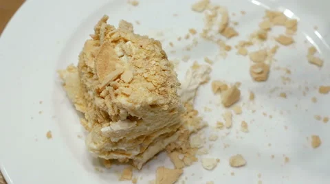 Cake being cut with fork on white plate and eaten Stock Footage 62350399