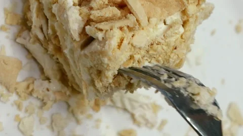 Cake being cut with fork on white plate and eaten Stock Footage 91165208