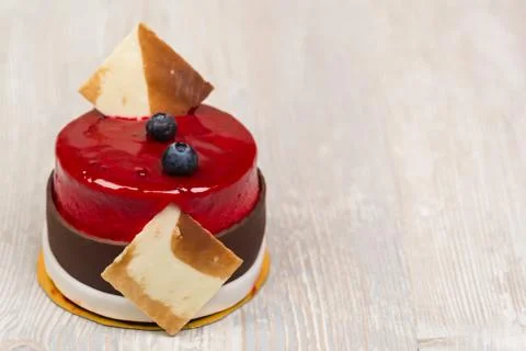 The cake with berries and glaze on the table Stock Photos