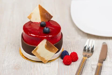 The cake with berries and plate on the table Foto stock