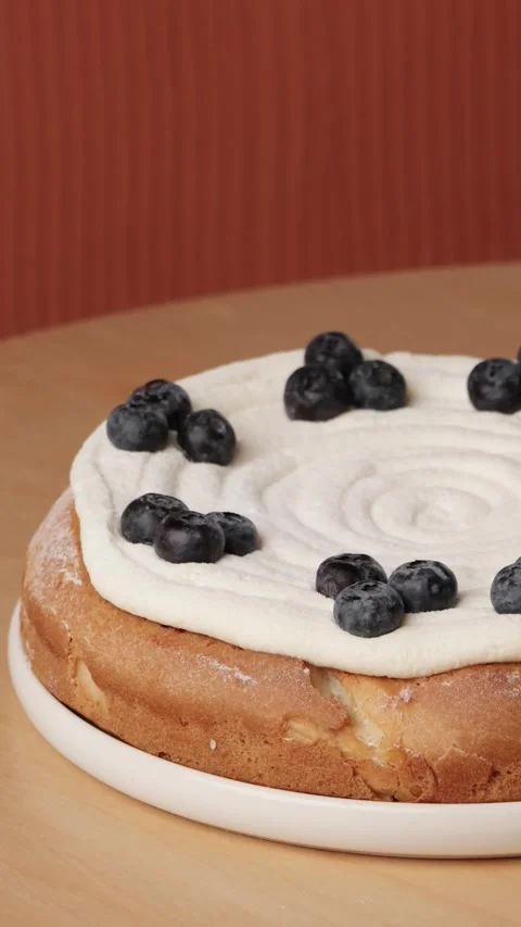Cake with blueberries on a pantone background vertical Stock Footage 262873783