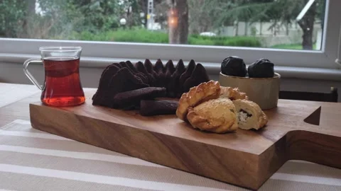 Cake, bun and tea on the serving board.4K Stock Footage 195641748