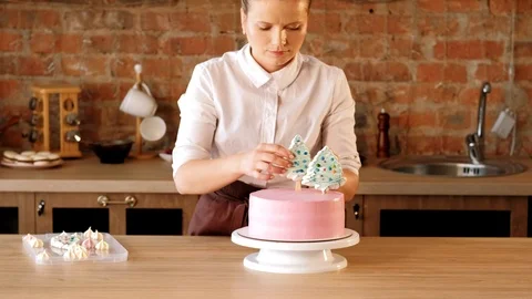 Cake business pastry chef decorating pink cake Stock Footage 112220396