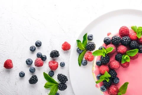 Cake with butter and fresh berries and fruits. Dessert. On a wooden backgroun Stock Photos