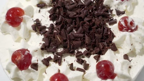 Cake Close-up decorated with cherries and chocolate shavings. Stock Footage 312198563