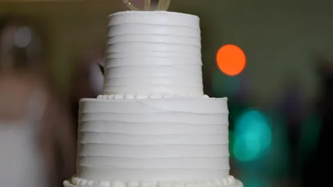 Cake close up pan right to left people in background Stock Footage 170376215