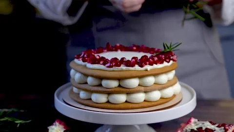 A cake consisting of three layers, cakes and white cream stands on a stand Stock Footage 170088733