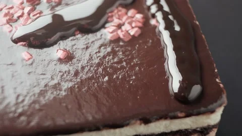The cake is covered with chocolate topping Stock Footage 189321820