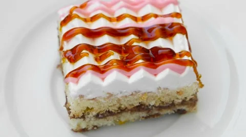 Cake with cream and different jams on top, rotating in a white plate Stock Footage 54340949