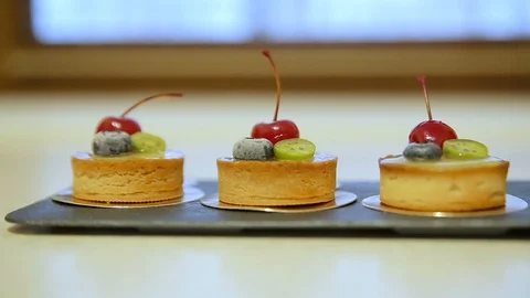 Cake decorated with fresh berries. Lemons tarts with blueberry and cherry Stock Footage 102368858