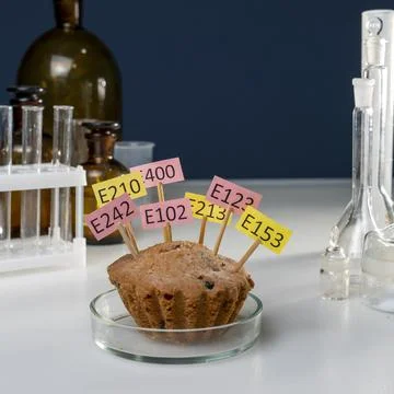 A cake decorated with tablets with the names of E. Food Laboratory additives on Stock Photos