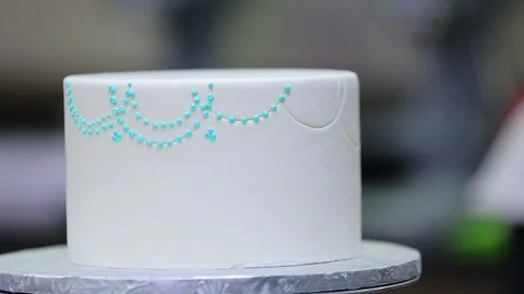 Cake decoration in progress. Baker about to ice Stock Footage 106944978