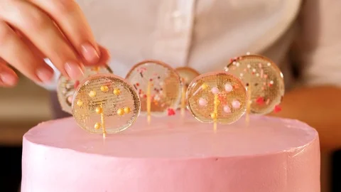 Cake decorator pastry chef lollipop cake pink Stock Footage 112220285