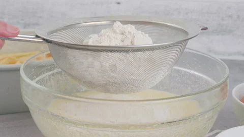 Cake dough preparation process. Chef pouring or sifting flour Stock Footage 232612405