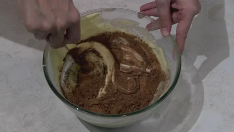 The cake dough is stirred with cocoa Stock Footage 164500769
