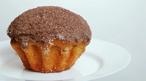 Cake dusted with chocolate rotates on the plate Stock Footage 58285689