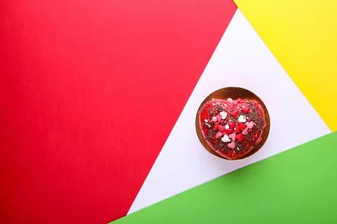 Cake in the form of a heart on a multi-colored background. Valentine's Day Stock Photos