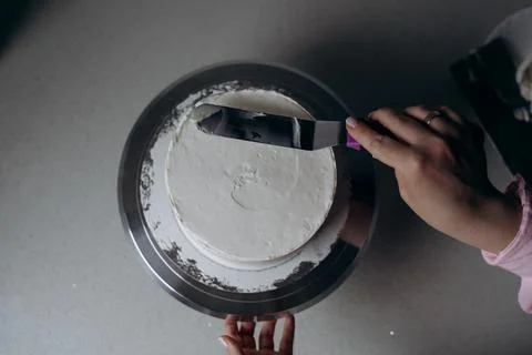 Cake Frosting in Progress by Skilled Baker Stock Photos