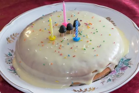 Cake handmade. Cake decorated with three candles and three mushrooms. Stock Photos