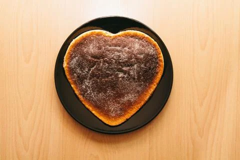 Cake with heart shape on plate Stock Photos