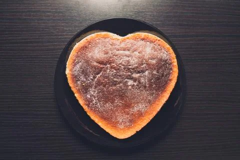 Cake with heart shape on plate Stock Photos