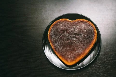 Cake with heart shape on plate Stock Photos
