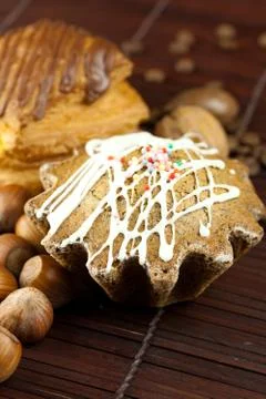 Cake with icing, cake with chocolate, coffee beans and nuts lying on a bamboo Stock Photos