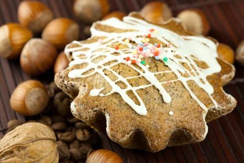 Cake with icing, coffee beans and nuts lying on a bamboo mat Stock Photos
