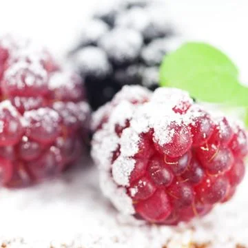 Cake with icing, raspberry, blackberry and mint  on a white background Stock Photos