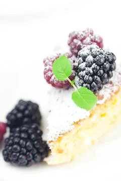 Cake with icing, raspberry, blackberry and mint  on a white background Stock Photos