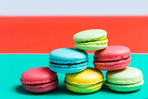 Cake macaron or macaroon on turquoise background, colorful cookies, pastel co Stock Photos
