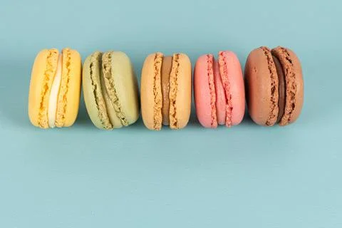 Cake macaron or macaroon on turquoise background from above, colorful almond  Stock Photos
