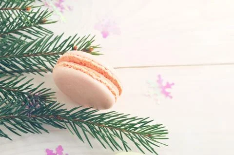Cake macarons with Christmas tree branches and snowflakes on wooden backgroun Stock Photos