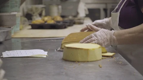 Cake maker cuts and prepares a custom cake Stock Footage 73899147