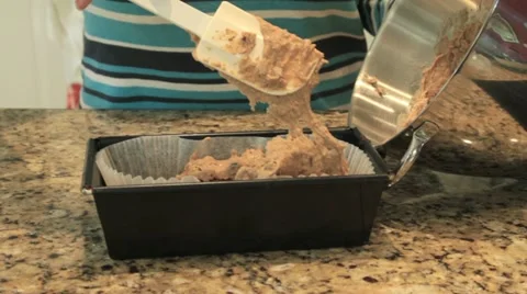 Cake mix being put into cake tin Stock Footage 10915765