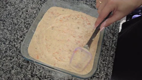 The cake mix prepared by the young cook is placed in the baking tray. Stock Footage 234784886