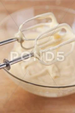 Cake Mixture In A Glass Bowl And On The Whisks Of The Mixer