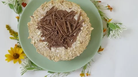 Cake with nuts and chocolate, decorated with chocolate chips. the cake is on a Stock-Footage 147475664