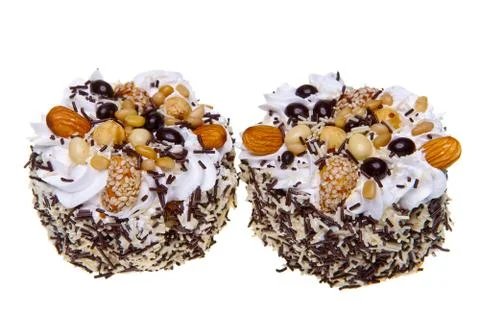Cake with nuts and whipped cream on a white background.. Stock Photos