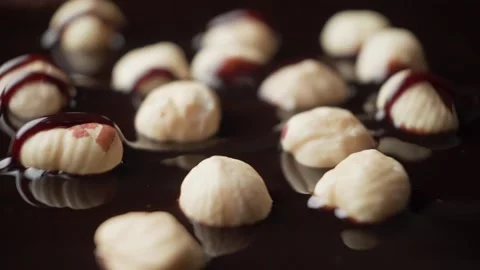 Cake with nuts is poured with chocolate Stock Footage 189323559