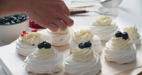 Cake Pavlova. The process of making a cake Pavlova. The pastry chef decorates Stock Footage 161192702