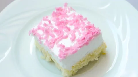 Cake with pink decoration rotates on white plate, top view Stock Footage 54228870